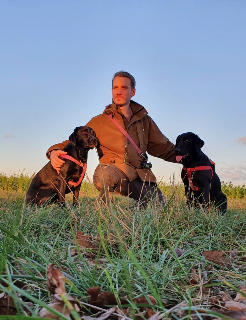 Olly Wilkes with his two black labradors, Tallulah and Dali