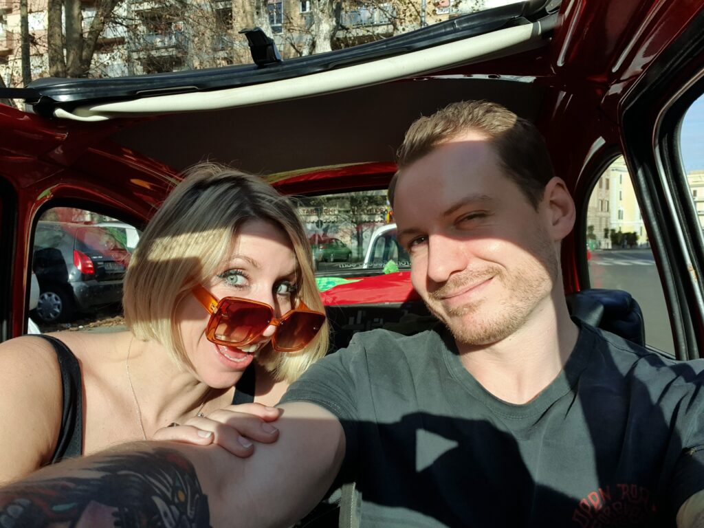 Olly and Abi in a fiat 500 in Rome, Italy